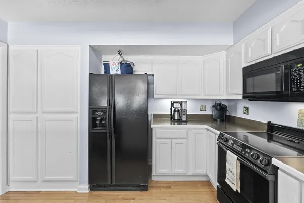 a kitchen with stainless steel appliances granite countertop a refrigerator stove and sink