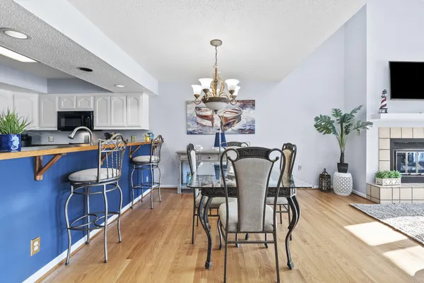 a dining room with furniture potted plants and wooden floor