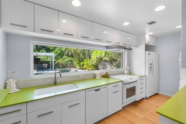a kitchen with a large window and couch