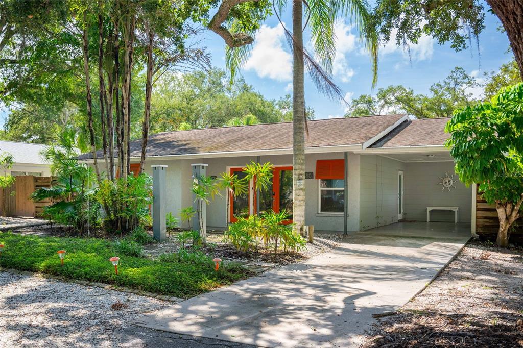 680 41st Street Sarasota, FL 34234 - Photo 2 of 42 a view of a house with potted plants and a large tree