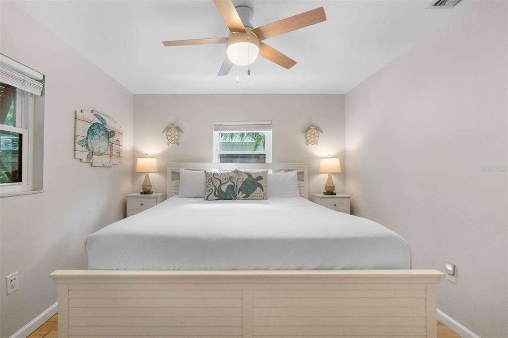 680 41st Street Sarasota, FL 34234 - Photo 21 of 42 a bedroom with a bed and a chandelier