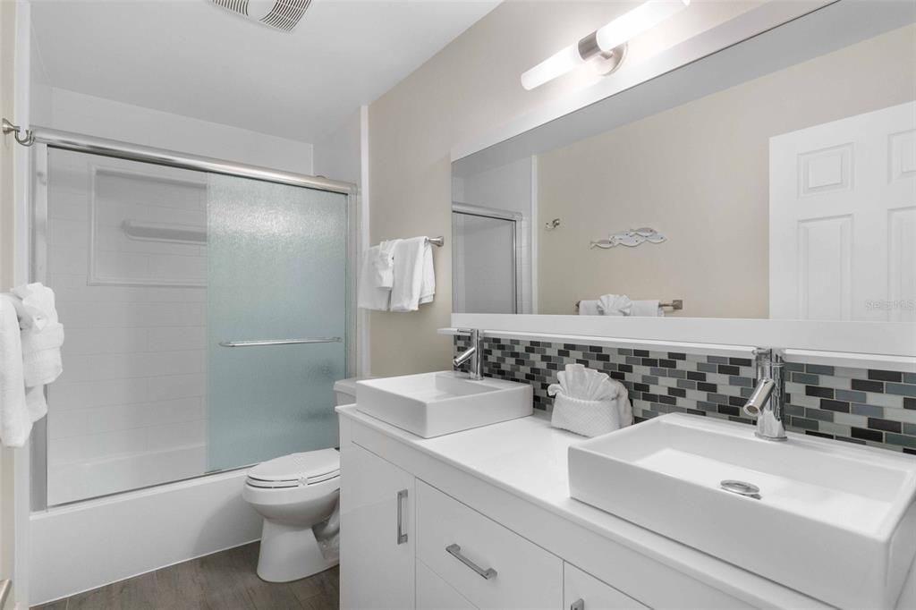 680 41st Street Sarasota, FL 34234 - Photo 23 of 42 a bathroom with a sink toilet and shower