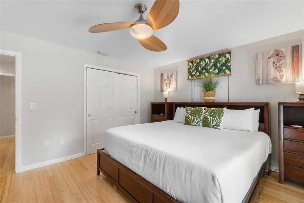 680 41st Street Sarasota, FL 34234 - Photo 24 of 42 a bedroom with a bed and a chandelier