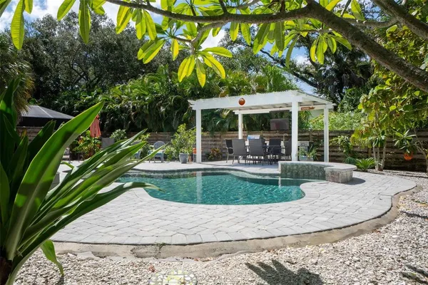 a view of a house with swimming pool and sitting area