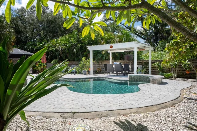 a view of a house with swimming pool and sitting area