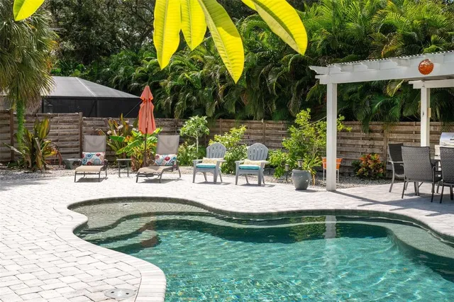 a view of a house with a yard patio and swimming pool