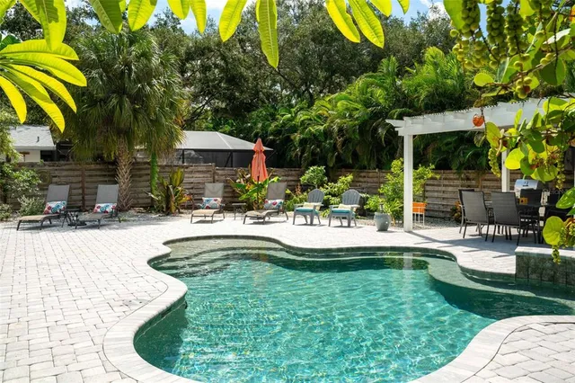 swimming pool view with a seating space