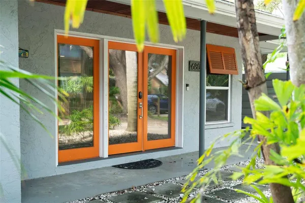 a living room with furniture a flat screen tv and a table