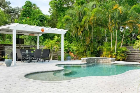 a view of a patio with a table chairs and a backyard