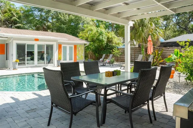 a view of house with backyard outdoor seating and hardwood floor