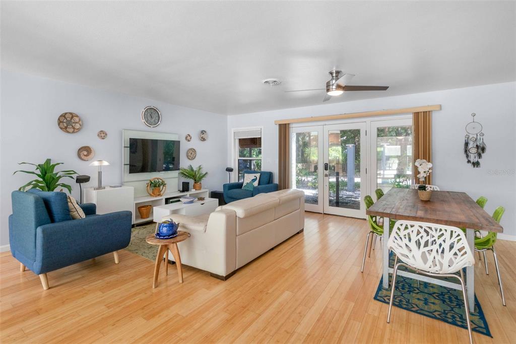 680 41st Street Sarasota, FL 34234 - Photo 7 of 42 a living room with furniture flat screen tv and a fireplace