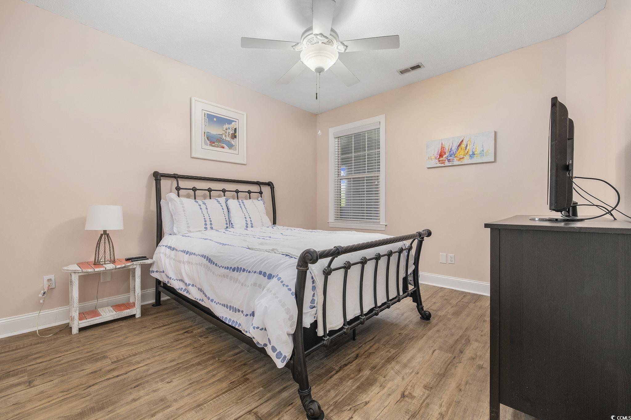131 Waypoint Ridge Avenue, Unit Q28 Little River, SC 29566 - Photo 19 of 36 Bedroom with ceiling fan and wood-type flooring