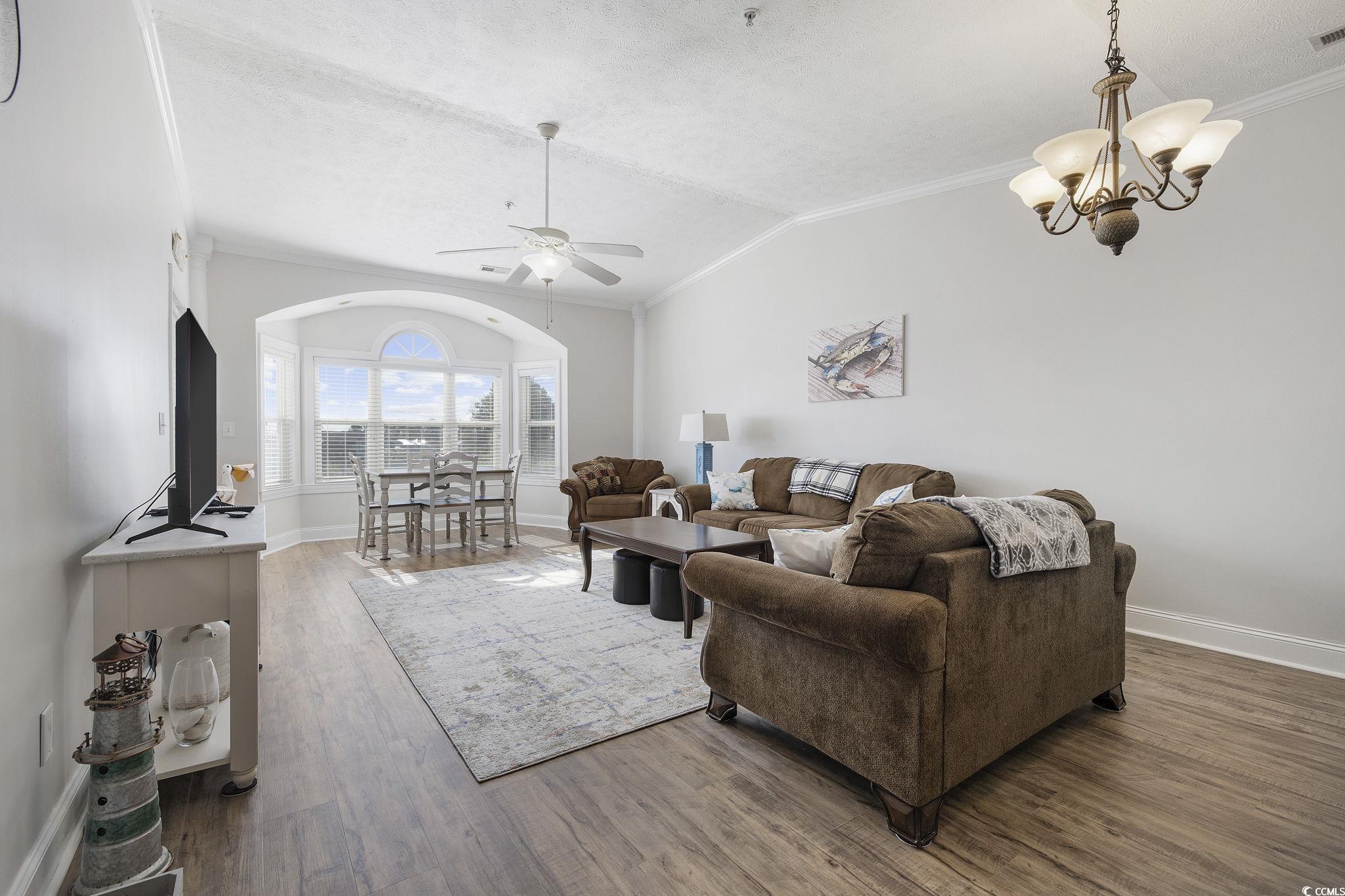131 Waypoint Ridge Avenue, Unit Q28 Little River, SC 29566 - Photo 5 of 36 Living room featuring ornamental molding, vaulted