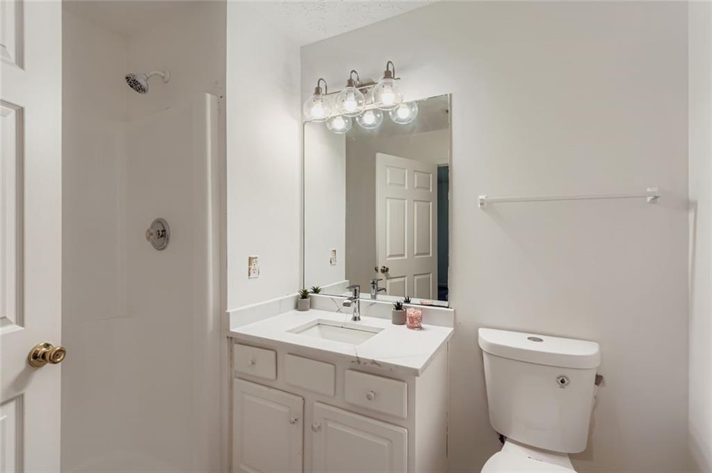 1025 Lakeside Circle Covington, GA 30016 - Photo 20 of 32 a bathroom with a sink vanity mirror and toilet