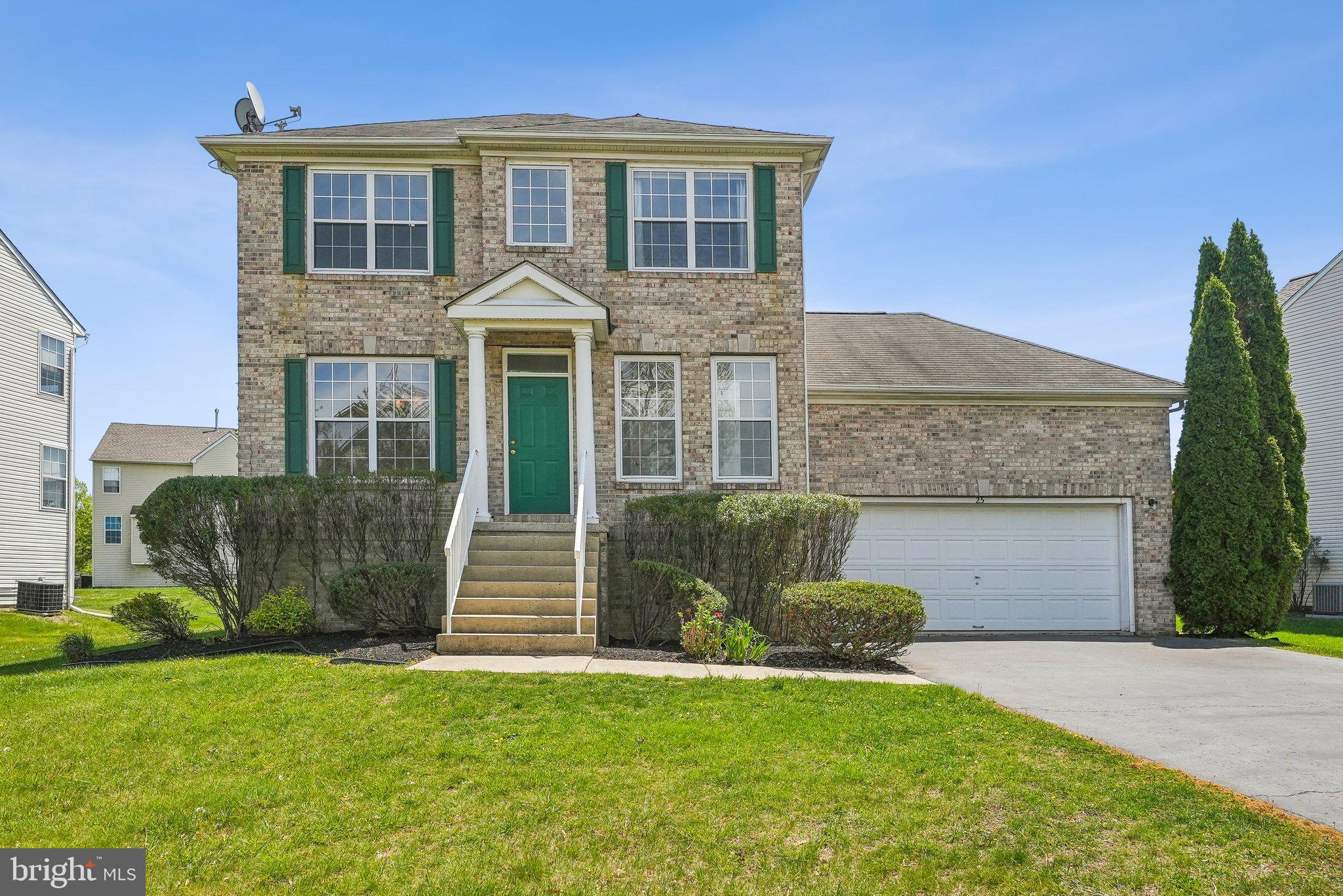 25 Keswick Road East Windsor, NJ 08520 - Photo 1 of 41 a front view of a house with a garden and plants