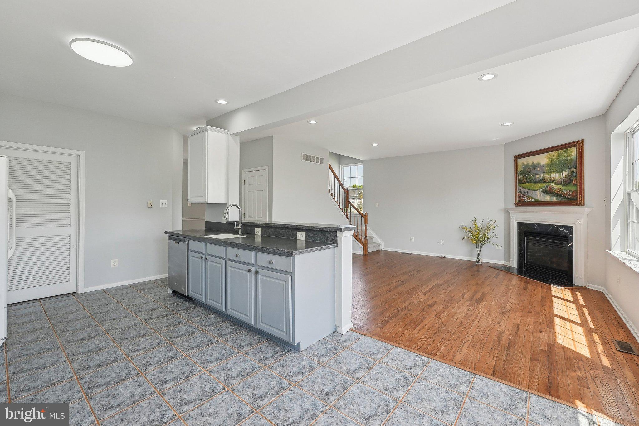 25 Keswick Road East Windsor, NJ 08520 - Photo 12 of 41 a kitchen with granite countertop a sink a stove and a wooden floors