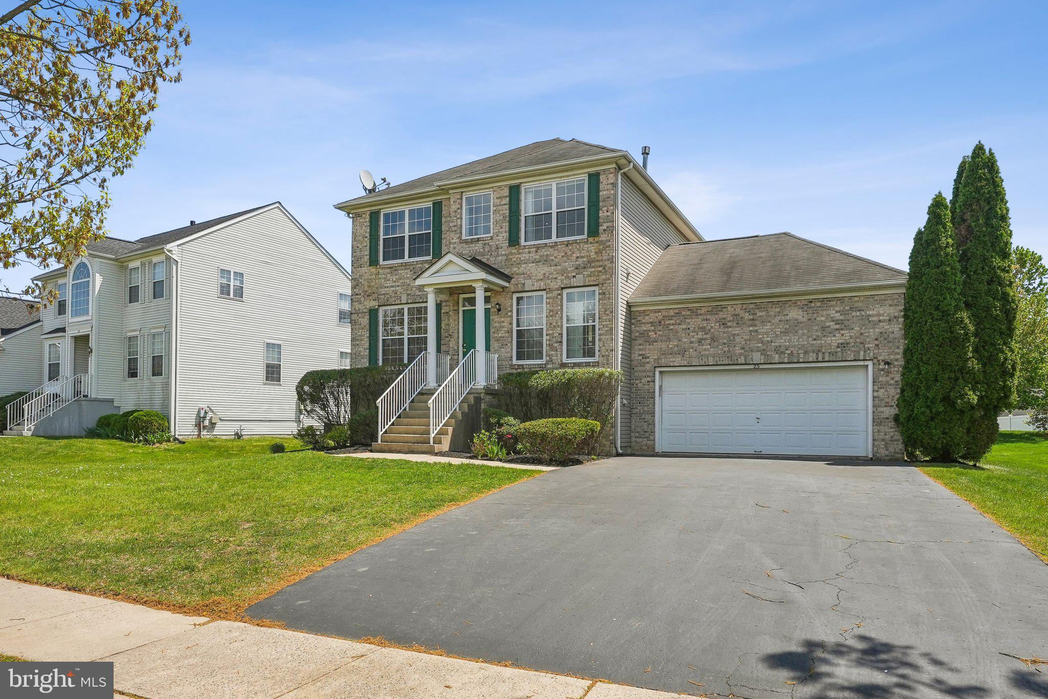 25 Keswick Road East Windsor, NJ 08520 - Photo 2 of 41 a front view of a house with a yard and garage