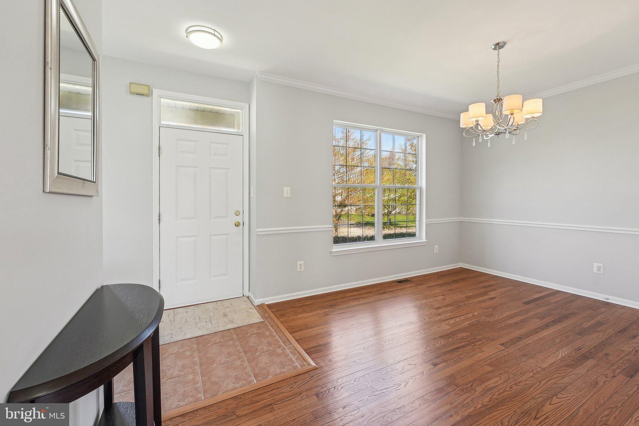 25 Keswick Road East Windsor, NJ 08520 - Photo 4 of 41 an empty room with wooden floor cabinet and windows