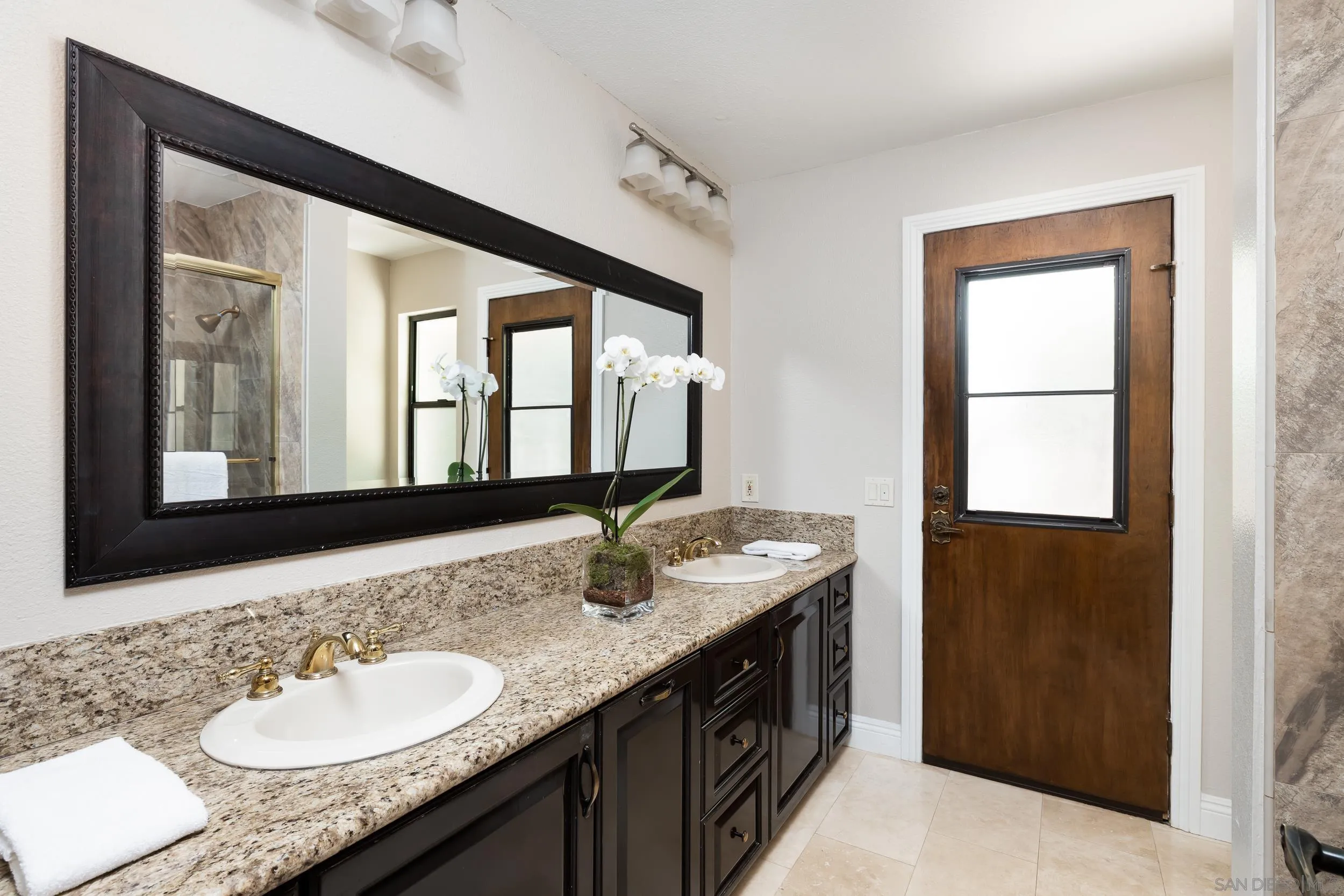 15951 Lime Grove Road Poway, CA 92064 - Photo 25 of 52 a bathroom with a granite countertop sink and a mirror
