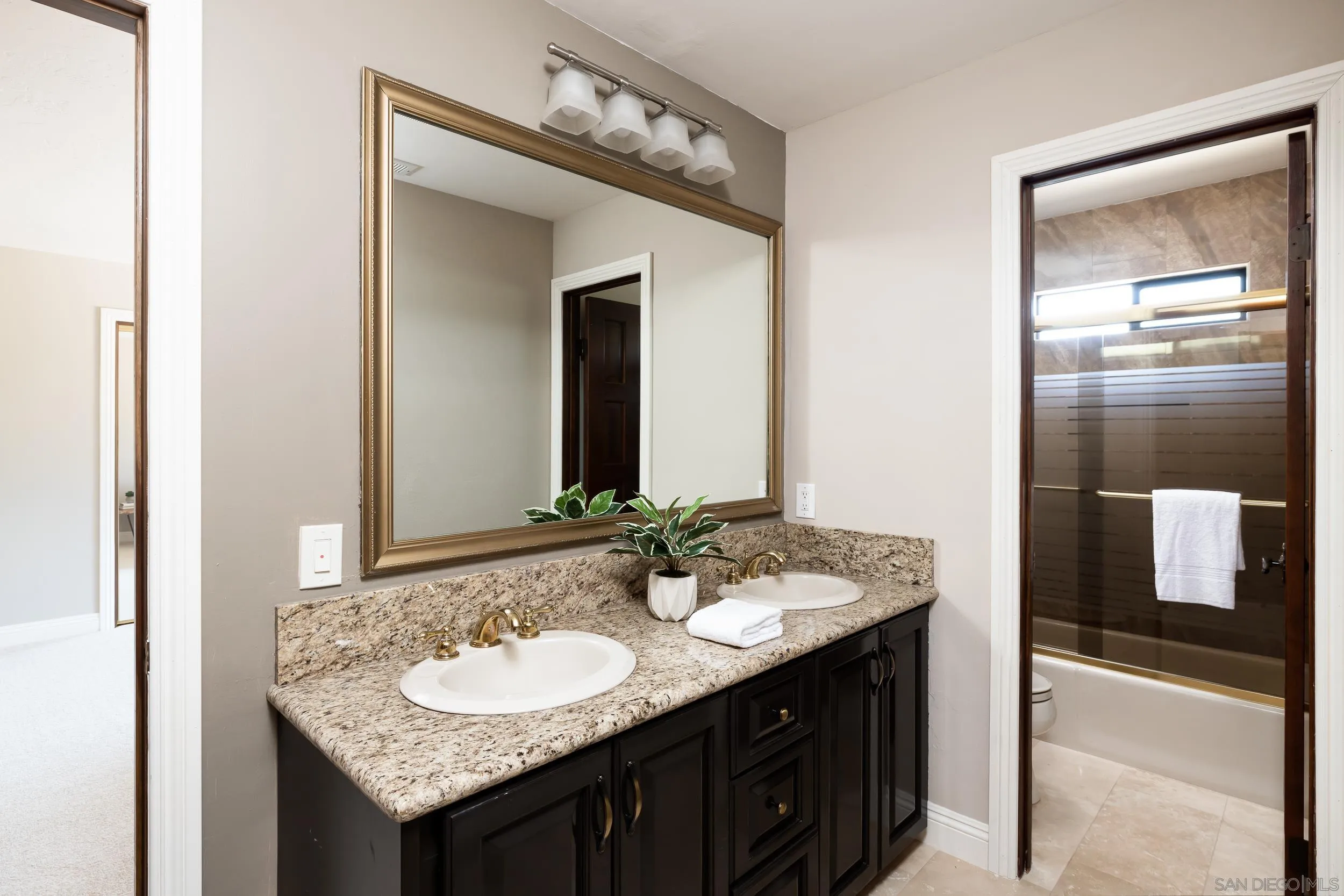15951 Lime Grove Road Poway, CA 92064 - Photo 27 of 52 a bathroom with a granite countertop sink and a mirror