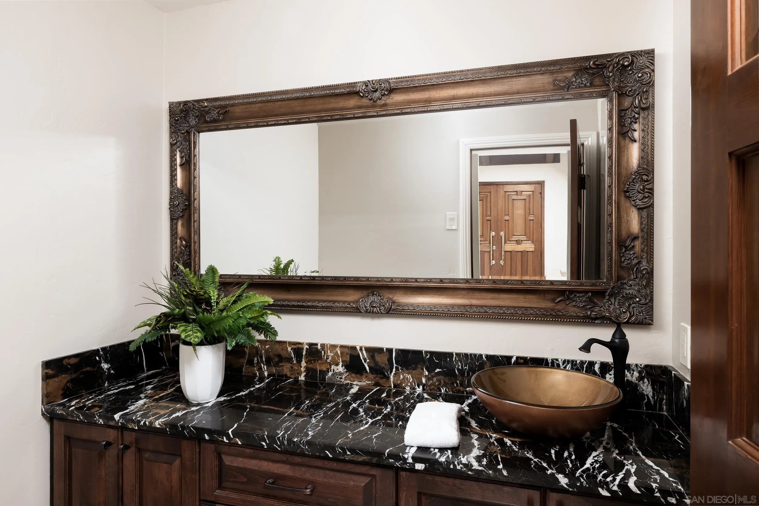 15951 Lime Grove Road Poway, CA 92064 - Photo 31 of 52 a bathroom with a sink a mirror and a potted plant