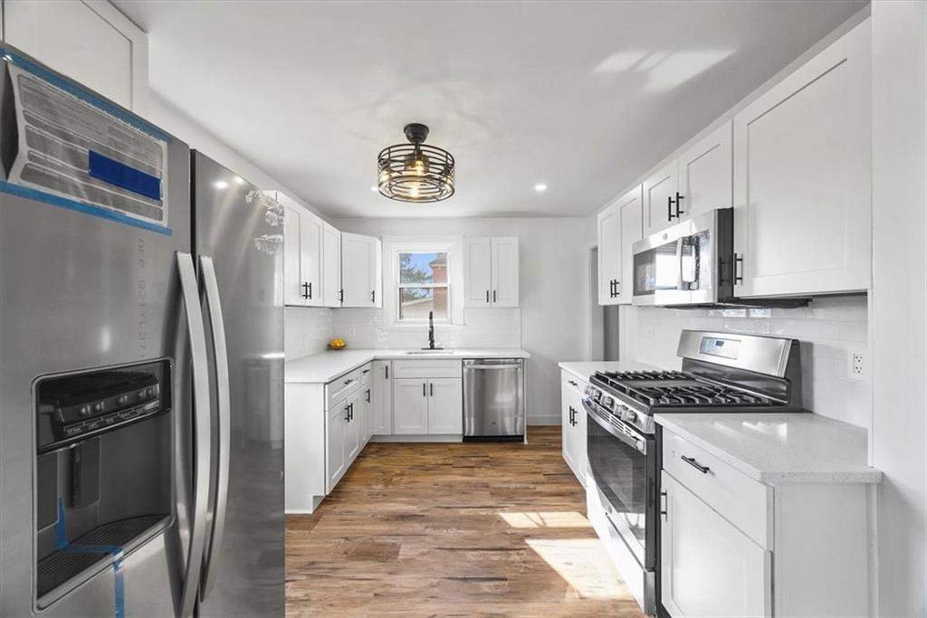 508 Maple Street West Mifflin, PA 15122 - Photo 9 of 31 a kitchen with stainless steel appliances a white stove top oven and cabinets
