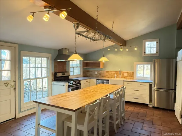 a kitchen with a table chairs and a refrigerator