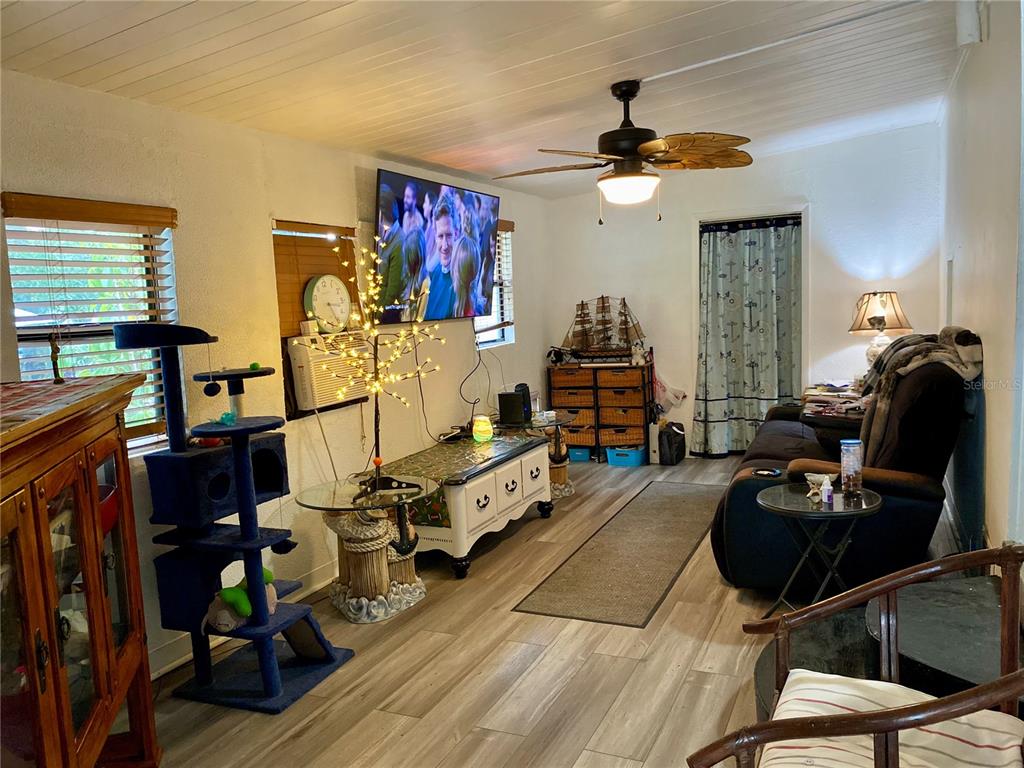 9475 Gray Fox Drive Weeki Wachee, FL 34613 - Photo 3 of 9 a living room with furniture a chandelier fan and a window