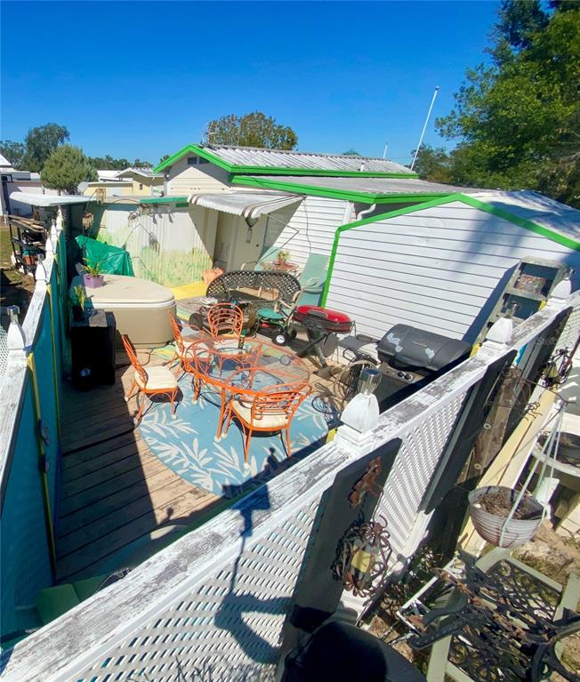 9475 Gray Fox Drive Weeki Wachee, FL 34613 - Photo 9 of 9 a view of a balcony with two chairs and a table
