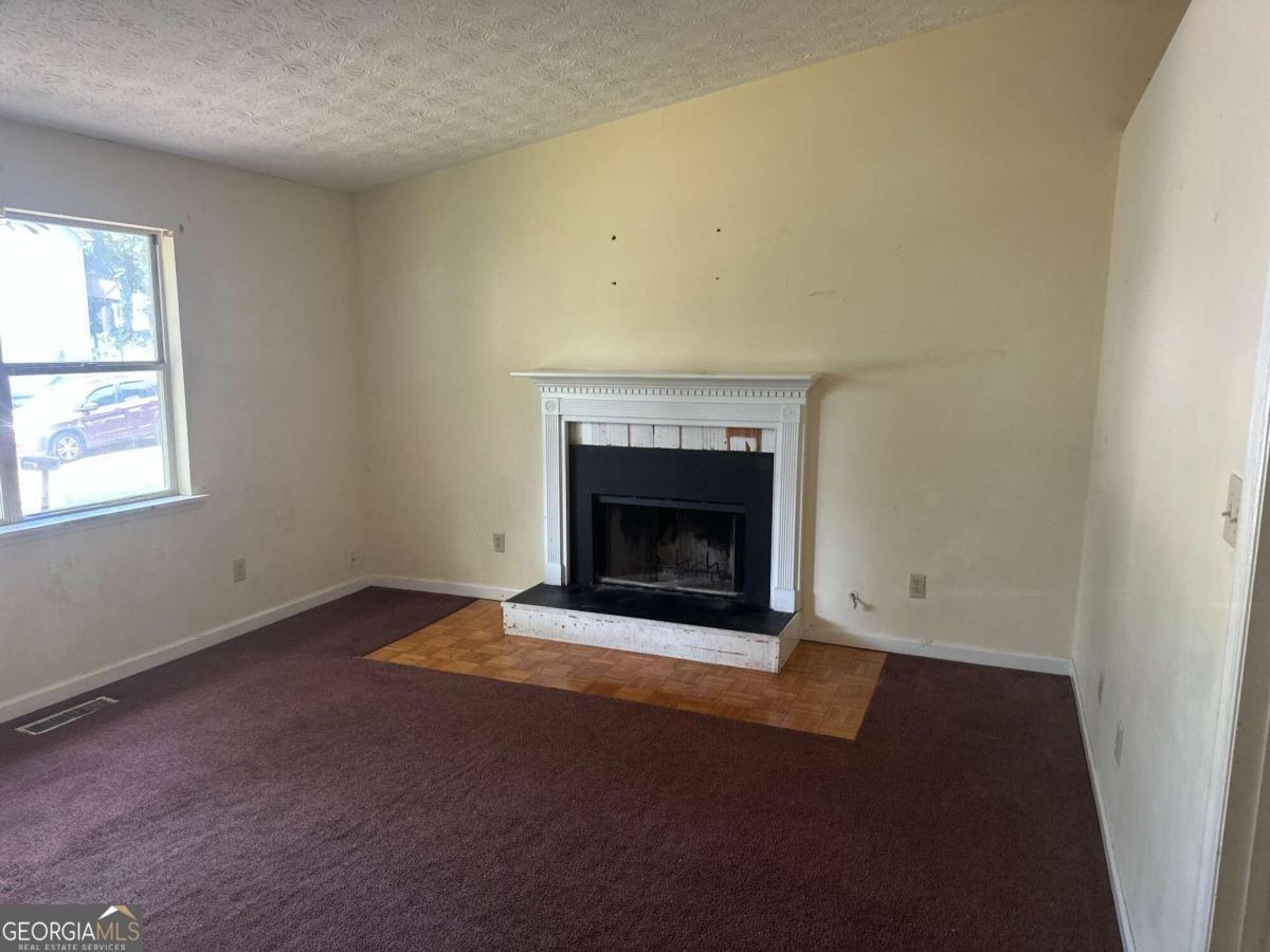 an empty room with a fireplace