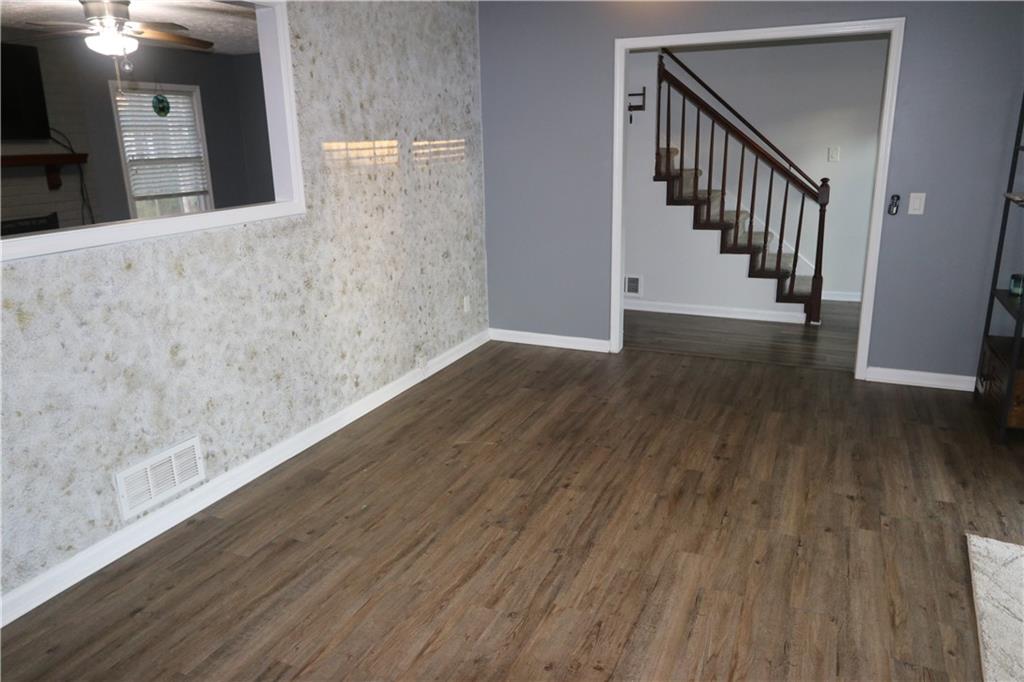 1302 Stephens Street Southwest Lilburn, GA 30047 - Photo 3 of 13 a view of a hallway with wooden floor and staircase