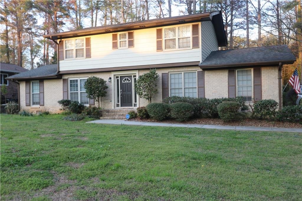 1302 Stephens Street Southwest Lilburn, GA 30047 - Photo 7 of 13 a front view of a house with garden
