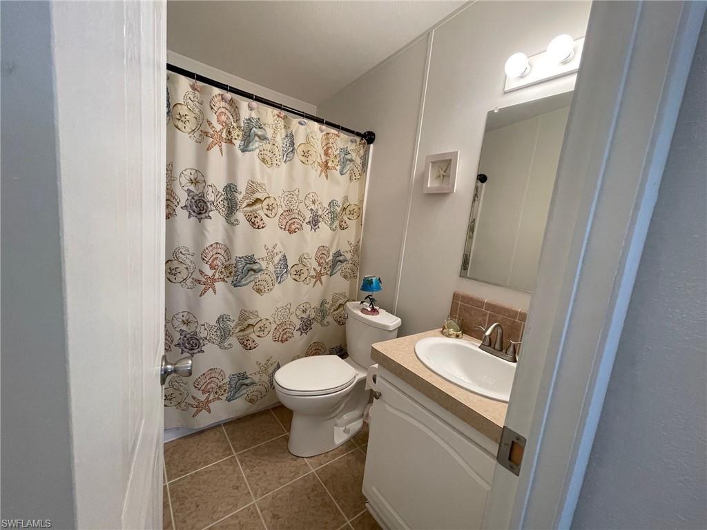 11262 Olive Circle Punta Gorda, FL 33955 - Photo 11 of 18 a bathroom with a sink toilet and shower