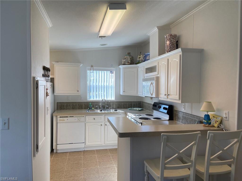 11262 Olive Circle Punta Gorda, FL 33955 - Photo 2 of 18 a kitchen with a sink cabinets and window