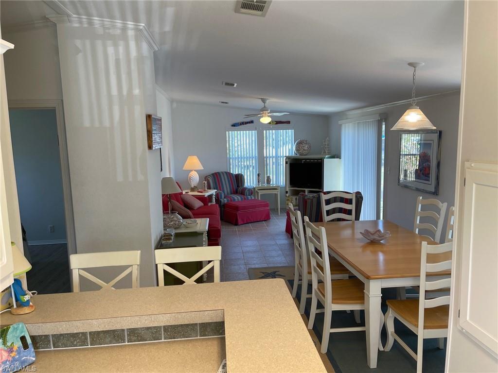 11262 Olive Circle Punta Gorda, FL 33955 - Photo 4 of 18 a view of a dining room with furniture and a flat screen tv
