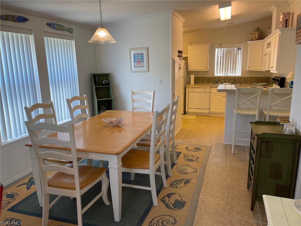 11262 Olive Circle Punta Gorda, FL 33955 - Photo 5 of 18 a view of a dining room with furniture and a chandelier