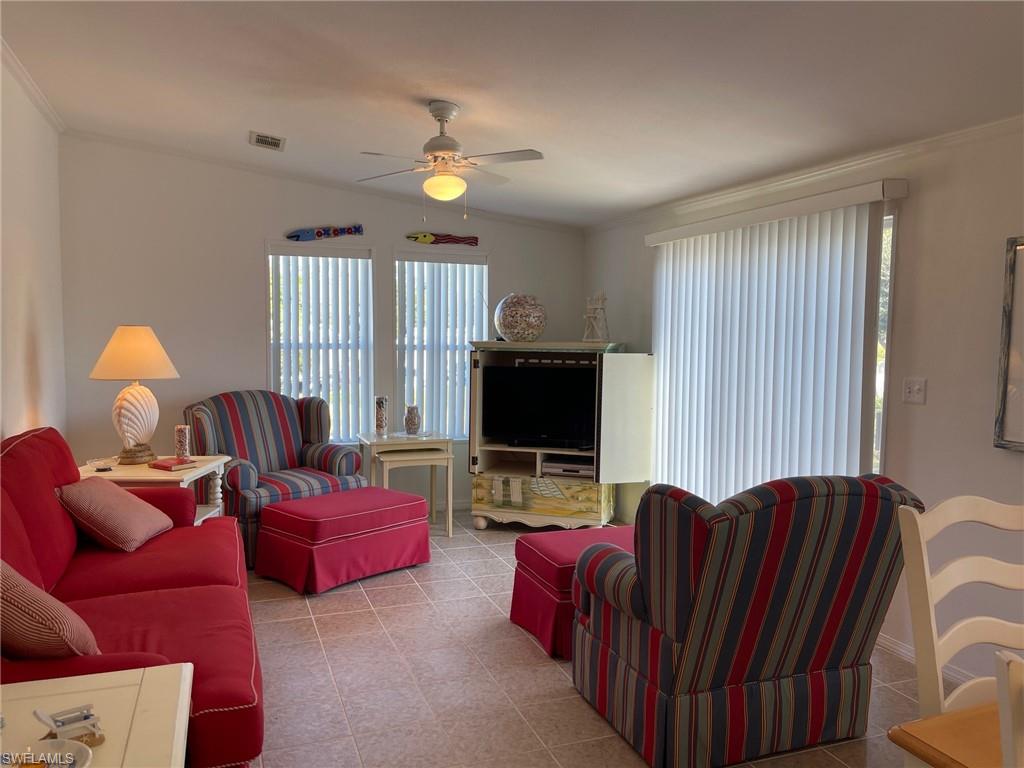 11262 Olive Circle Punta Gorda, FL 33955 - Photo 8 of 18 a living room with furniture a ceiling fan and a window