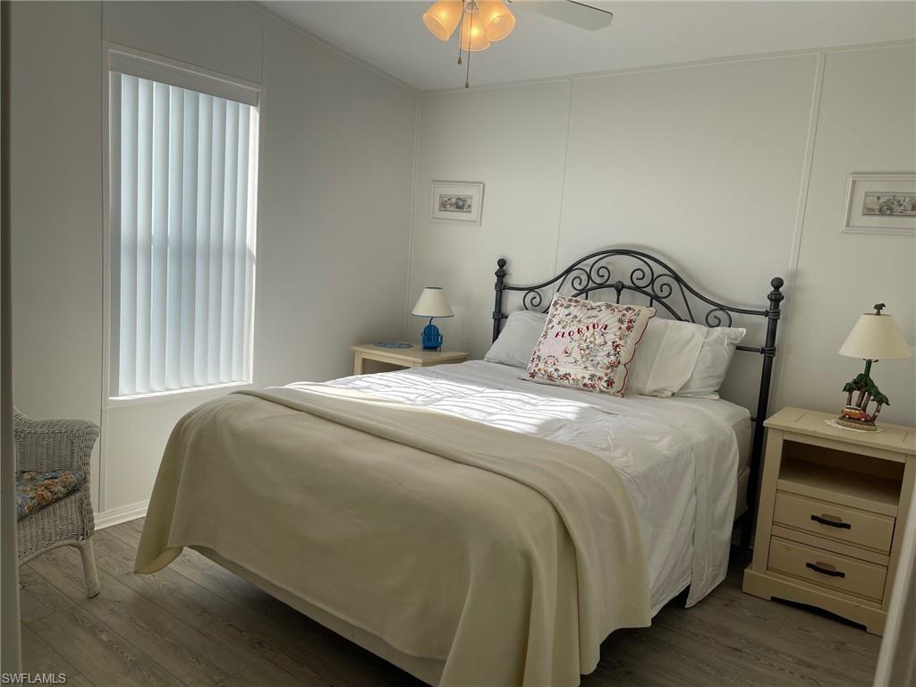 11262 Olive Circle Punta Gorda, FL 33955 - Photo 9 of 18 a bedroom with a bed and a chandelier