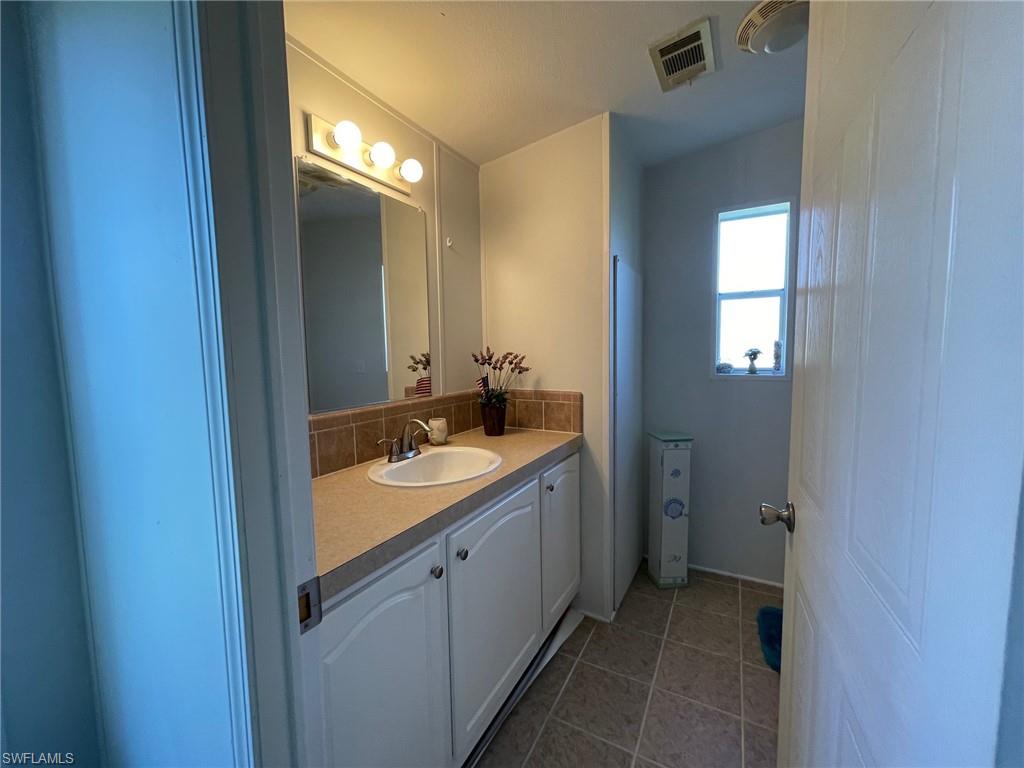 11262 Olive Circle Punta Gorda, FL 33955 - Photo 10 of 18 a bathroom with a sink and a mirror