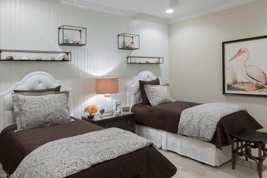 2295 Sawyers Hill Road, Unit 1007 Naples, FL 34120 - Photo 3 of 12 a bedroom with furniture and a lamp