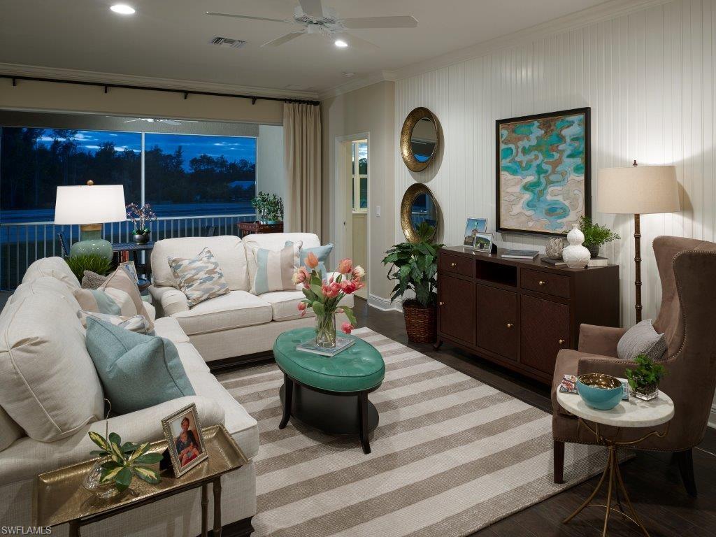 2295 Sawyers Hill Road, Unit 1007 Naples, FL 34120 - Photo 5 of 12 a living room with furniture and a large window