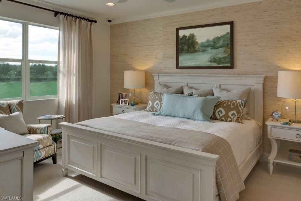 2295 Sawyers Hill Road, Unit 1007 Naples, FL 34120 - Photo 7 of 12 a bedroom with a bed and a painting on the wall