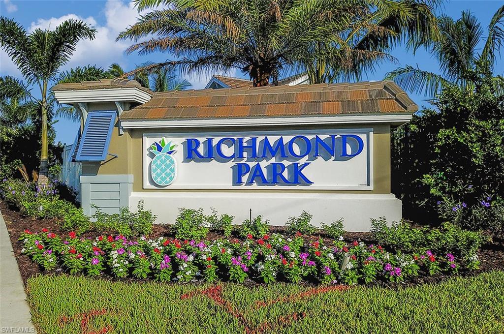 2295 Sawyers Hill Road, Unit 1007 Naples, FL 34120 - Photo 8 of 12 a sign that is in front of flowers