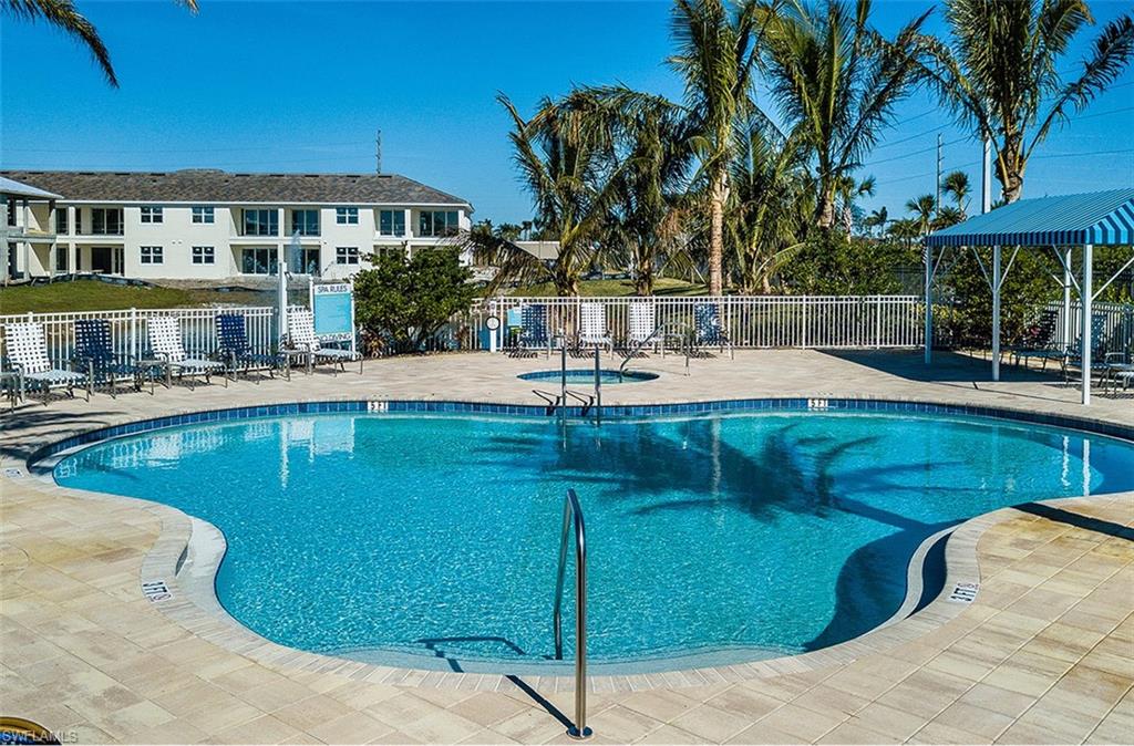 2295 Sawyers Hill Road, Unit 1007 Naples, FL 34120 - Photo 10 of 12 a view of a swimming pool with a patio