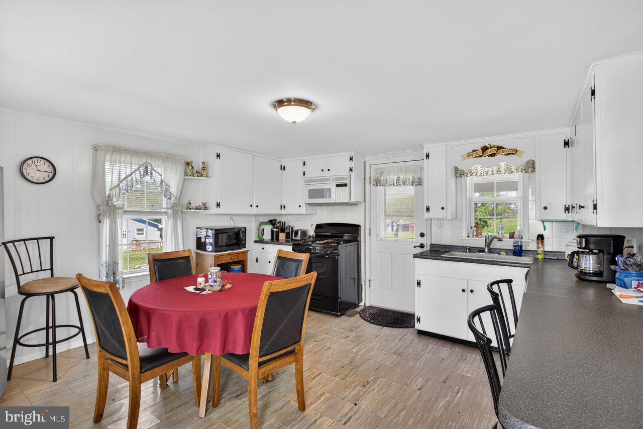 1751 Orchard Road Mount Jackson, VA 22842 - Photo 7 of 30 a view of a dining room with furniture and a kitchen