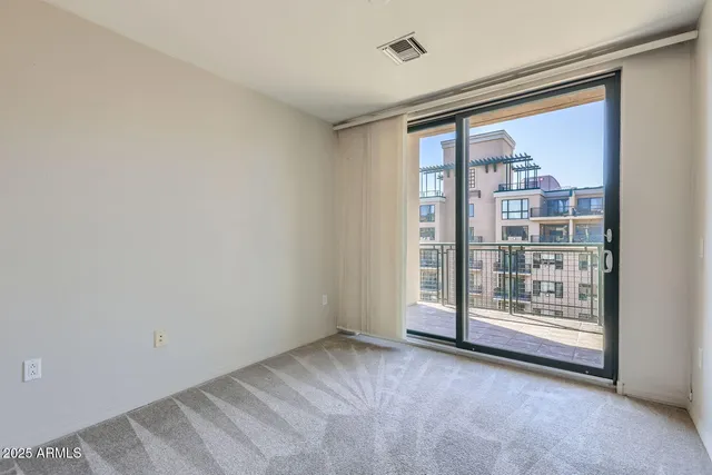a bedroom with a large bed and a large window