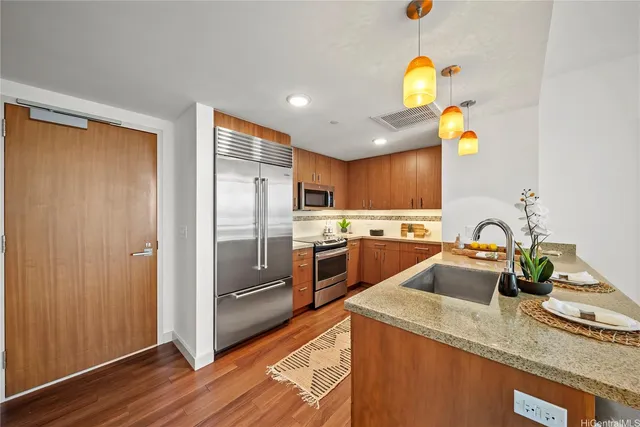 a kitchen with a sink appliances and cabinets