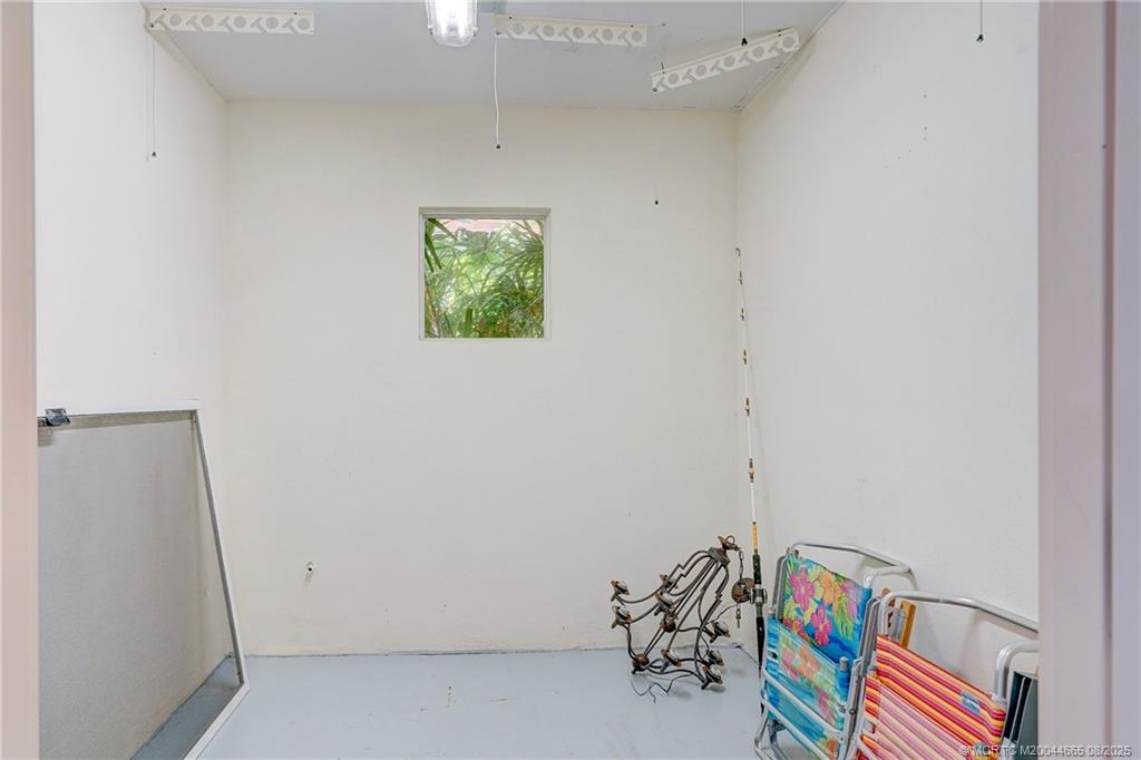 1528 Northeast Outrigger Landings Drive, Unit 208 Jensen Beach, FL 34957 - Photo 12 of 79 a room with toys and a book shelf