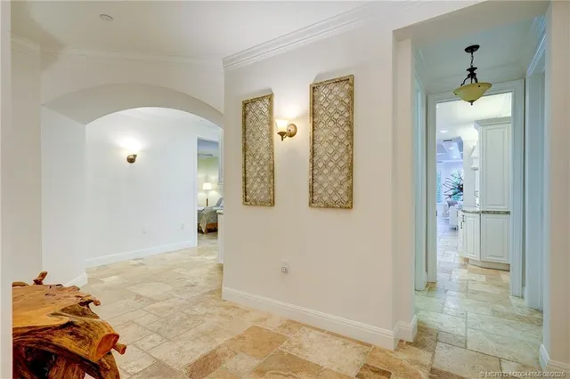 a living room with furniture floor to ceiling window and a flat screen tv