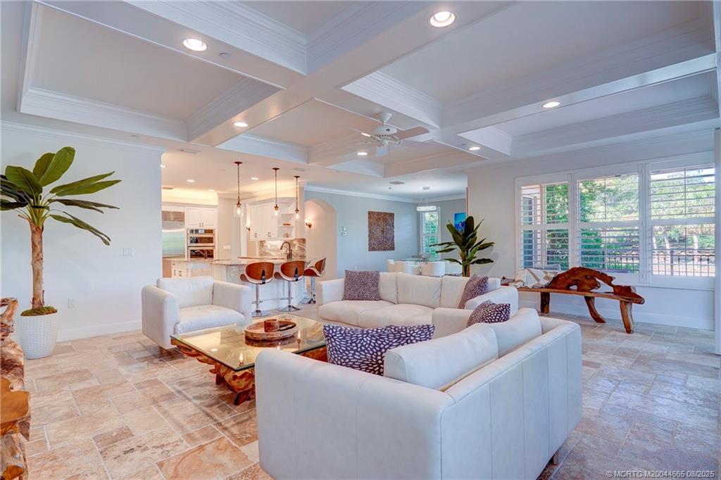 1528 Northeast Outrigger Landings Drive, Unit 208 Jensen Beach, FL 34957 - Photo 24 of 79 a living room with furniture and a large window